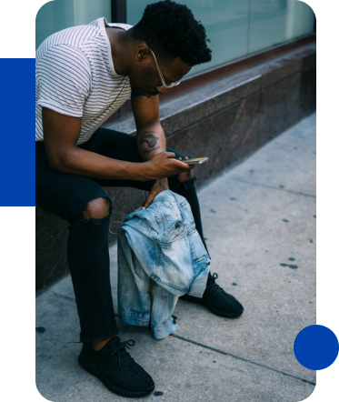 Photo of a teenage african male looking at Phone